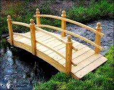 a wooden bridge over a small stream