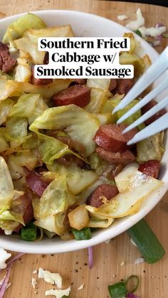 a white bowl filled with cabbage and sausage