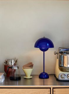 a blue lamp sitting on top of a wooden counter