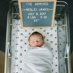 a baby in a hospital bed with a sign above it that says i've arrived westley james july 8, 2011