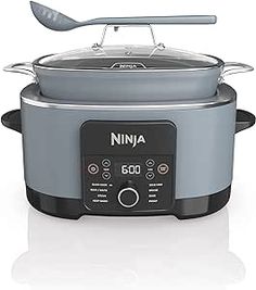 the ninja slow cooker has two spoons on it's handle and is ready to cook