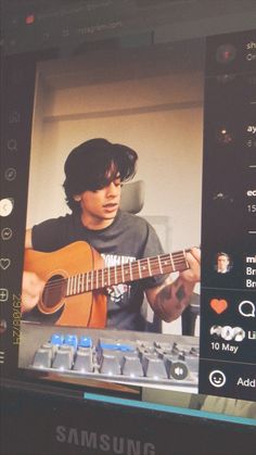 a man playing an acoustic guitar in front of a computer screen with the caption samsung