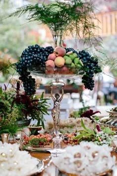 an assortment of fruits and vegetables on a platter in front of other food items