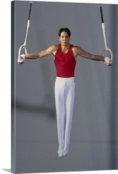 a woman in red shirt doing aerial acrobatics with two hands and one leg