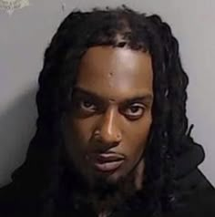 mug shot of man with dreadlocks