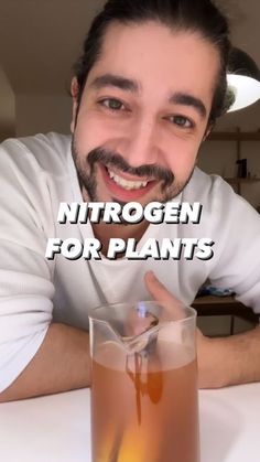 a man sitting at a table with a glass in front of him and the words hydrogen for plants above it