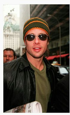 a man wearing sunglasses and a knitted hat