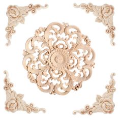 an intricately carved piece of wood with flowers and scrolls on the sides, set against a white background