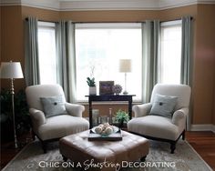 a living room with two chairs and a coffee table in front of a window that reads, office on a second floor decor