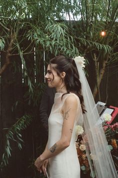 a bride and groom standing next to each other