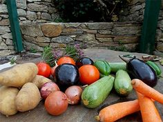 there are many different types of vegetables on the table together, including carrots and eggplant