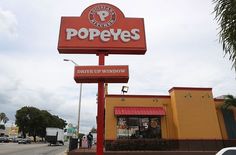 a sign for pope's drive up window in front of a store