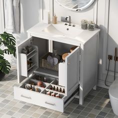 a bathroom with a sink, mirror and cabinet in it's center area next to a toilet