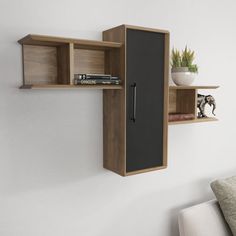 a wall mounted shelf with two open shelves on each side and a book case in the middle