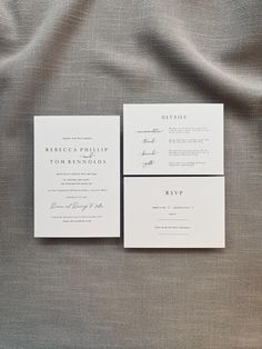 the wedding stationery is laid out on top of the linen