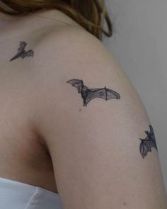 a woman with a bat tattoo on her shoulder