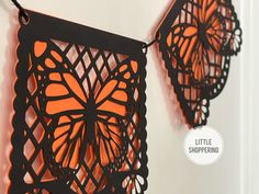 two paper butterflies hanging on the wall