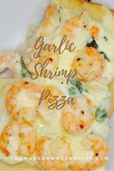 a close up of a pizza on a plate with the words garlic shrimp pizza above it