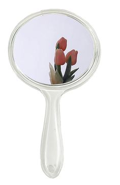 a mirror with flowers in it reflecting the reflection of another flower on its own side