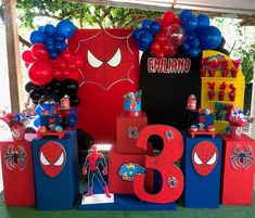 a birthday party with spiderman decorations and balloons