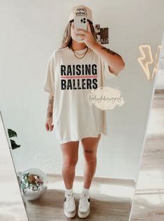 Raising ballers Shirt, Comfort Colors® Retro Baseball, Mother's Day Gift, Motherhood Shirt, Mom Life Tee, Softball Mom, Baseball Mama 📋 HOW TO ORDER: 1. Select the size ( Comfort Colors® Fit is true to size - please size up 2 sizes for oversized look) 2. Select the color  3. Select the quantity  4. Add personalization if required 5.Add to Cart ("buy now" will take you directly to checkout and "add to cart" will allow you to continue shopping with us) 6. Submit order (Shipping will automatically Mom Baseball Game Outfit, Baseball Mom Gear, Relaxed Fit Tops With Team Name For Football Season, White Relaxed Fit Shirt For Game Day, Sports Fan Relaxed Fit Top With Team Name, Relaxed Fit Tops For Football Season, White Slogan Top For Sports Events, Relaxed Fit Tops With Text Print For Sports Events, Baseball Mom Aesthetic