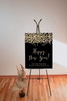 a black and gold new year's eve sign on top of a wooden easel