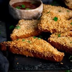 breaded pastries with dipping sauce and parsley sprinkled on the side