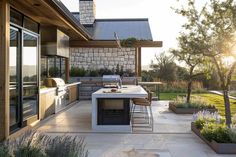 an outdoor kitchen and dining area is shown