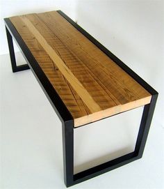 a wooden table with black metal legs on a white background and no people around it