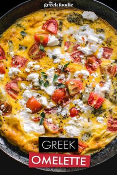 an omelette with tomatoes, cheese and herbs in a cast iron skillet