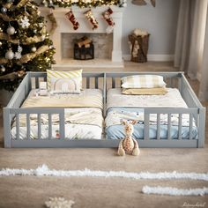 a baby crib in front of a christmas tree with stuffed animals on the floor