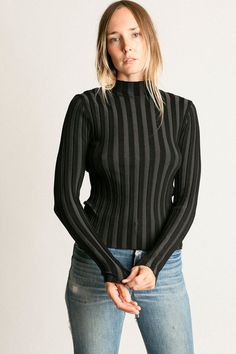 Mock neck rib knit top with long sleeves. Ella is 6' tall, 35" bust, 26" waist, 36" hip, and is wearing a size S. Winter Ribbed Stretch Tops, Long Sleeve Ribbed Knit Turtleneck, Ribbed Tops For Workwear In Winter, Ribbed Knit Long Sleeve Turtleneck, Ribbed Tops For Winter Workwear, Ribbed Tops For Winter, Ribbed Knit Turtleneck With Long Sleeves, Ribbed Winter Workwear Top, Long Sleeve Stretch Knit Top For Work