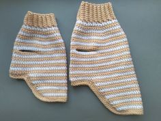 two crocheted mittens sitting next to each other