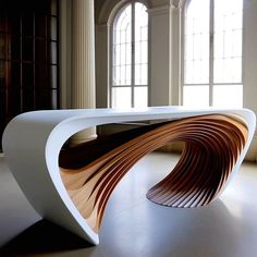 a large white table sitting in the middle of a room next to two tall windows