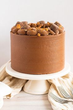 a chocolate cake sitting on top of a white plate