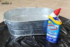 an aluminum tub with cleaner and cloth next to it