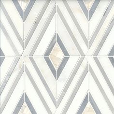 a white and gray tiled wall with diamond shapes