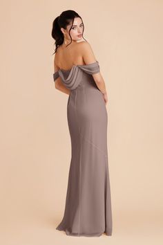 the back of a woman wearing a grey dress with one shoulder and an open - back