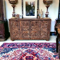 an ornately carved wooden sideboard in a living room