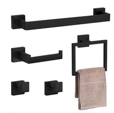 black bathroom accessories set with towel and soap dispenser on white back ground