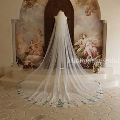 a wedding veil hanging in front of a painting