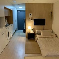 a bed sitting in a bedroom next to a washer and dryer