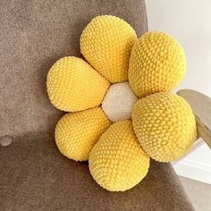 a bunch of yellow balls sitting on top of a chair