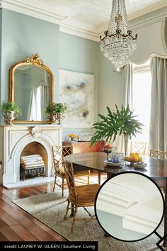 a dining room with a table and chairs in front of a mirror on the wall