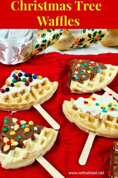 christmas tree waffles with chocolate and sprinkles are on a red cloth