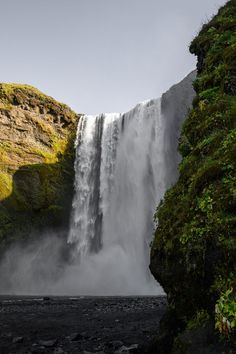 a large waterfall with water cascading down it's sides