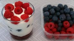 berries, yogurt and blueberries are sitting next to each other in plastic containers