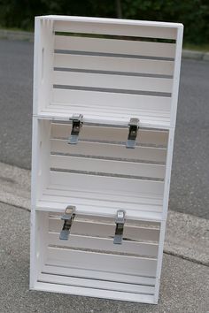 two white boxes sitting on the side of a road