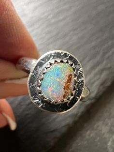 Boulder opal sterling ring, size M 1/2 US 6 1/2, colourful bezel set silver jewellery, gift for her My venture into the world of rings Featuring a bezel set boulder opal set in sterling silver. The unique stone sits atop a  sterling silver band which has been hammered, oxidised and polished.  This ring size is M US 6 1/4. This ring cannot be re-sized. The stone measures 7mm x 6mm approximately. **My style is organic and rustic. I pride myself on my attention to  detail, however whilst I think at Sterling Silver Opal Ring With Bezel Setting, Sterling Silver Opal Ring With Bezel Setting As Gift, Fine Jewelry Hallmarked Opal Ring Gift, Sterling Silver Spiritual Opal Ring, Gift Opal Ring With Bezel Setting In Sterling Silver, White Gold Opal Gemstone Ring For Gift, Gift White Gold Opal Gemstone Ring, Unique White Gold Opal Ring Gift, Fusion Style Round Opal Ring