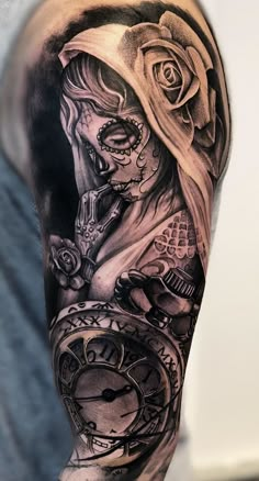 a man with a clock and roses tattoo on his arm